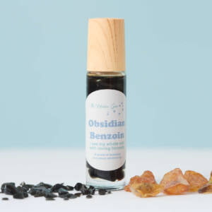 obsidian and benzoin positive affirmation oil, glass bottle, crystal roller ball, full of small polished obsidian, essential oil and sweet almond oil