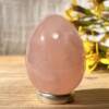 rose quartz yoni egg with a hole drilled to hold a cord which is provided but not shown